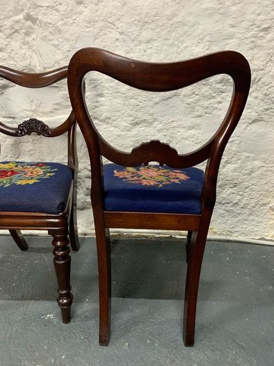 A pair of Victorian mahogany balloon back chairs with tapestry seats.
