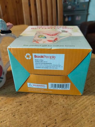 Butterfly Shaped Handle Ceramic Mug, decorated with various colorful butterfly graphics. 3D ceramic butterfly molded directly onto the handle. New in Box.