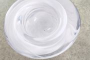 A Small Kosta Boda Art Glass Bowl with White Swirl Detail