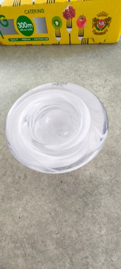 A Small Kosta Boda Art Glass Bowl with White Swirl Detail
