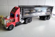 Model large plastic model truck with car trailer and ten cars on one side
