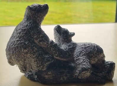 The figurine is a bears sculpture, manufactured by Wolf Originals in Canada.