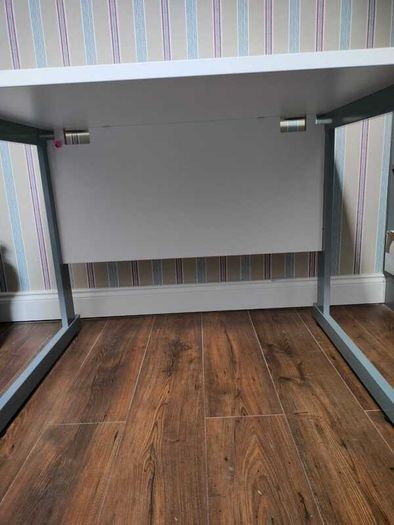 Modern white office desk with grey metal frame
