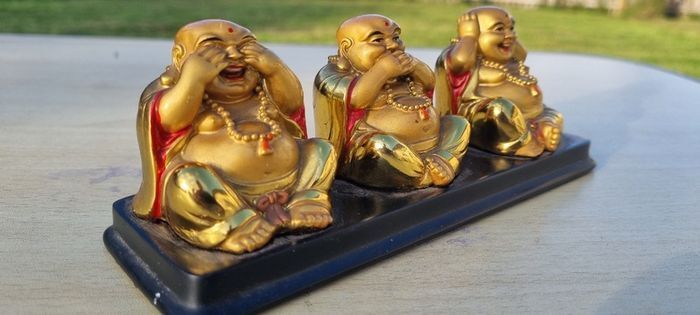Three brass Buddha figurines
