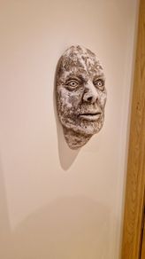 Hanging Roman head sculpture