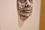 Hanging Roman head sculpture