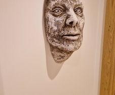 Hanging Roman head sculpture