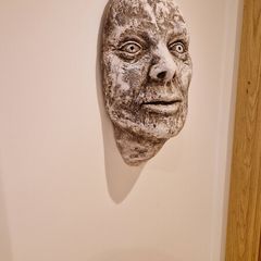 Hanging Roman head sculpture