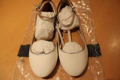 White flat pumps with silver ankle strap