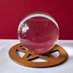 Crystal glass ball on wooden pentagram base.