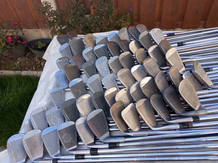 A selection of golf clubs and bags. All right handed clubs.