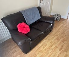 Comfortable brown leather two-sit sofa.