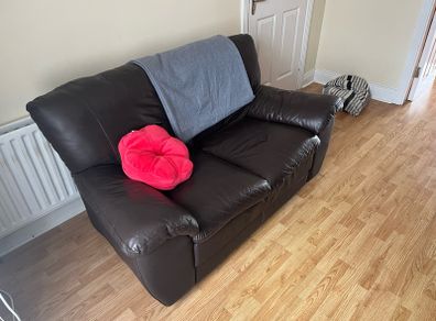 Comfortable brown leather two-sit sofa.