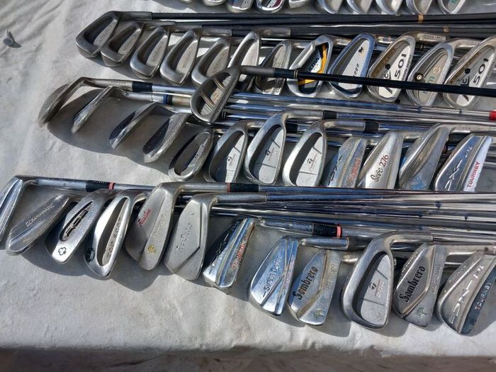 A selection of Golf clubs. Bags and golf balls.