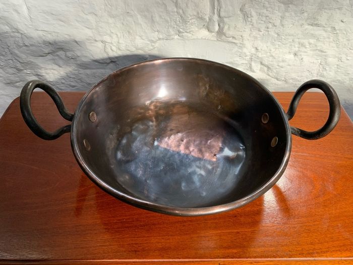 Large heavy antique copper dish with ring handles.
