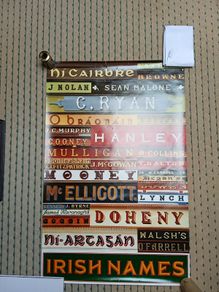 Large poster of Irish name signs on shops and pubs
