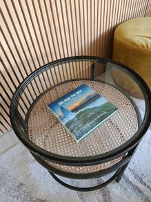 Round glass and rattan side table