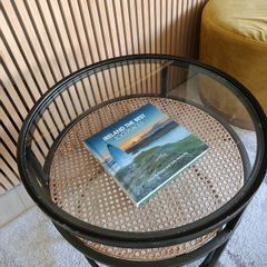 Round glass and rattan side table