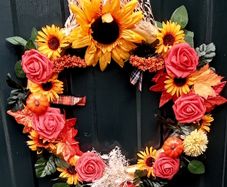 Autumnal door wreath with sunflowers and roses