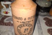 Antique stoneware ginger beer bottle from the Norfolk brewer Steward &amp; Patteson Limited, featuring a "1D" (one penny) price mark