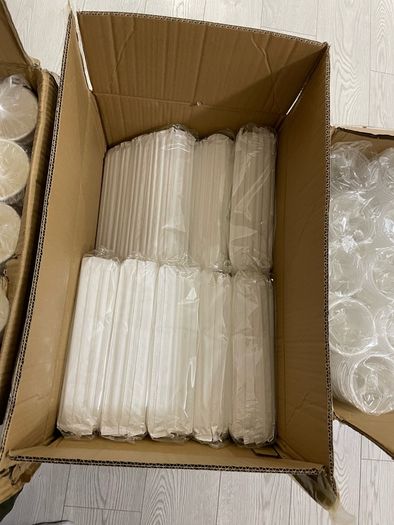 A box of Paper cups and a box of straws