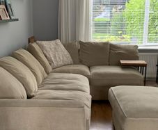 Corner sofa with footstool