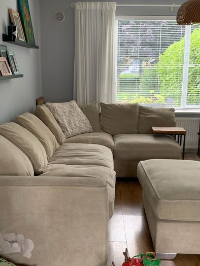 Corner sofa with footstool