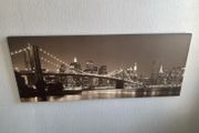 This sepia-toned panoramic canvas print features a classic night view of the Brooklyn Bridge and the New York City skyline