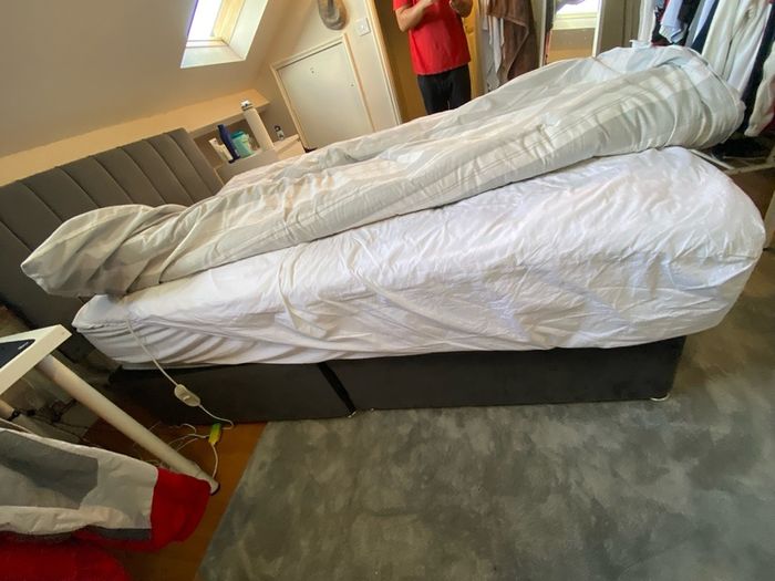 Grey double bed and mattress