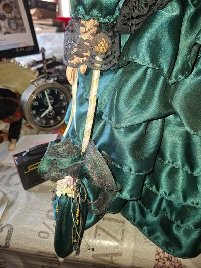 Vintage Large Victorian-style collectible Porcelain Doll featuring curly reddish-brown hair and a multi-layered emerald green satin and lace dress