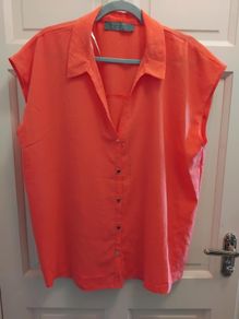 orange short sleve blouse 14 to 16 but big fit size 18