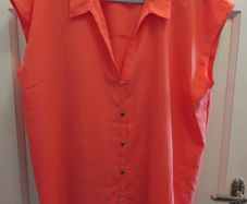 orange short sleve blouse 14 to 16 but big fit size 18