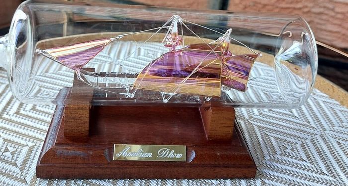 Blown Glass "Arabian Dhow" Sailing Ship Housed in Clear Glass Bottle.