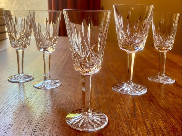 Four Waterford Crystal Lismore Sherry Glasses, One Lismore Small Wine Glass, 1970s.