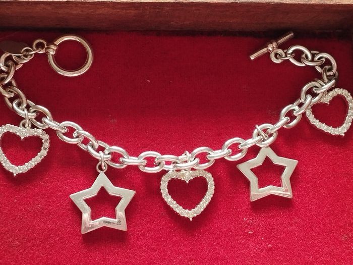 A fashionable bracelet with silver-tone charms.