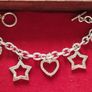 A fashionable bracelet with silver-tone charms. Image 2