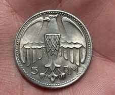 1935 Adolf Hitler fantasy 5 Reichsmark coin. These are collectible tokens or replicas, as Hitler never appeared on official circulating German coinage