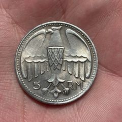 1935 Adolf Hitler fantasy 5 Reichsmark coin. These are collectible tokens or replicas, as Hitler never appeared on official circulating German coinage