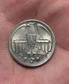 1935 Adolf Hitler fantasy 5 Reichsmark coin. These are collectible tokens or replicas, as Hitler never appeared on official circulating German coinage