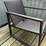 Brown rattan outdoor table and rocking chair Image 3