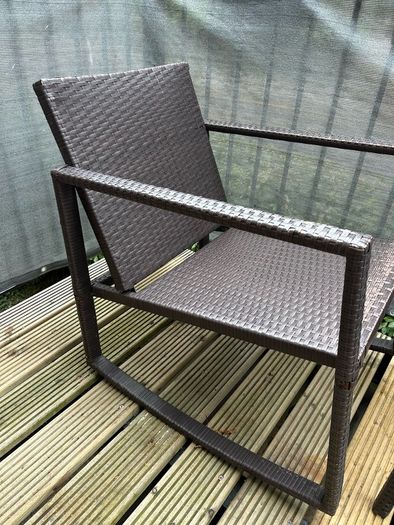 Brown rattan outdoor table and rocking chair