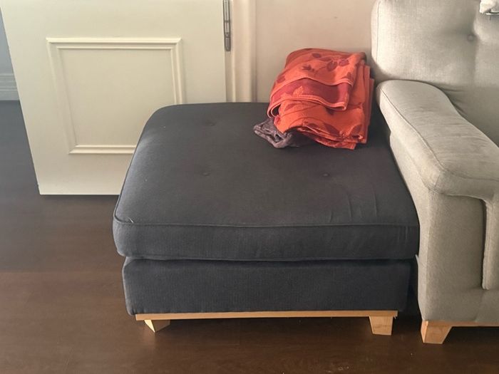 Grey 2-seater sofa with navy ottoman