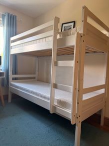 White bunk bed and mattresses