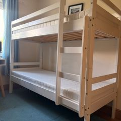 White bunk bed and mattresses