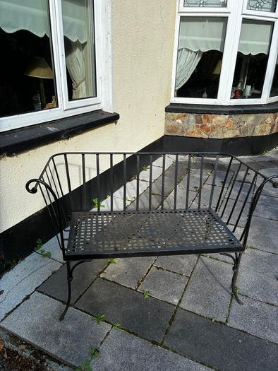 Curved wrought iron garden bench