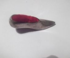 a vintage solid silver pin cushion in the shape of a shoe