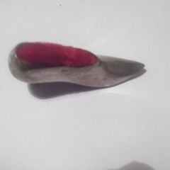 a vintage solid silver pin cushion in the shape of a shoe