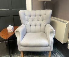 Grey button-back armchair