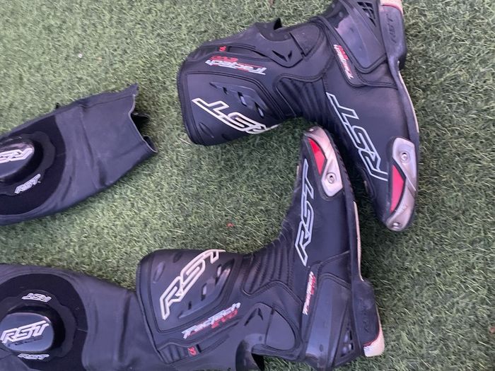 Motor cycle racing leathers with boots, gloves and helmet.
