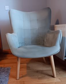 Grey velvet armchair with wooden legs
